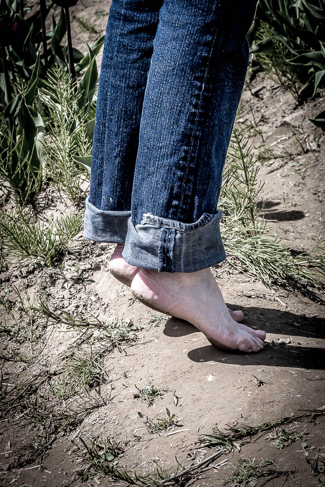 Barefoot and Loving It - Walking through the tulip fields with bare feet, in Skaggit County, WA. by Scott Smith Photos