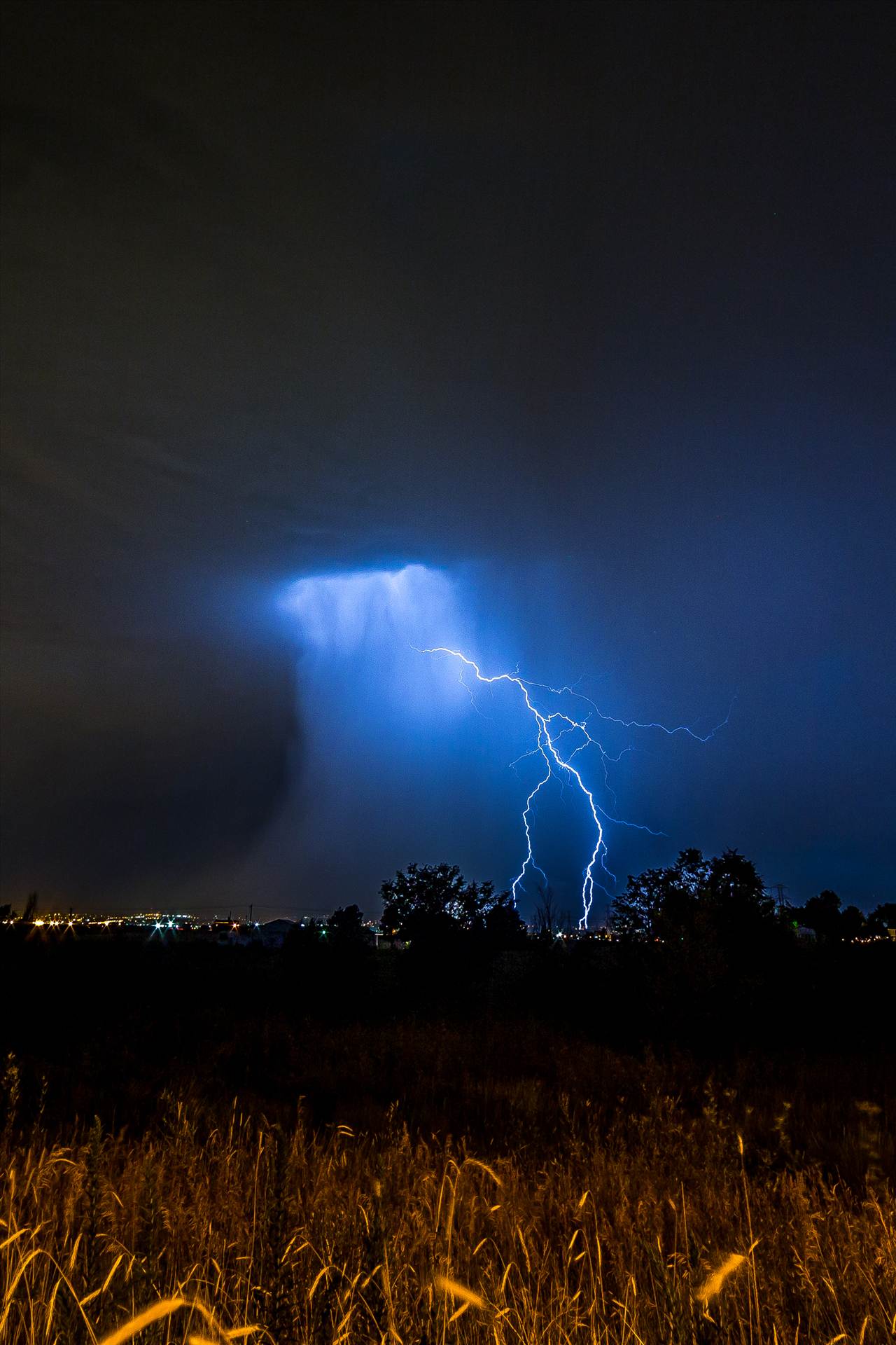 Lightning Flashes 3 - A series of shots from the end of the street, during a powerful lightning storm near Reunion, Colorado. by Scott Smith Photos