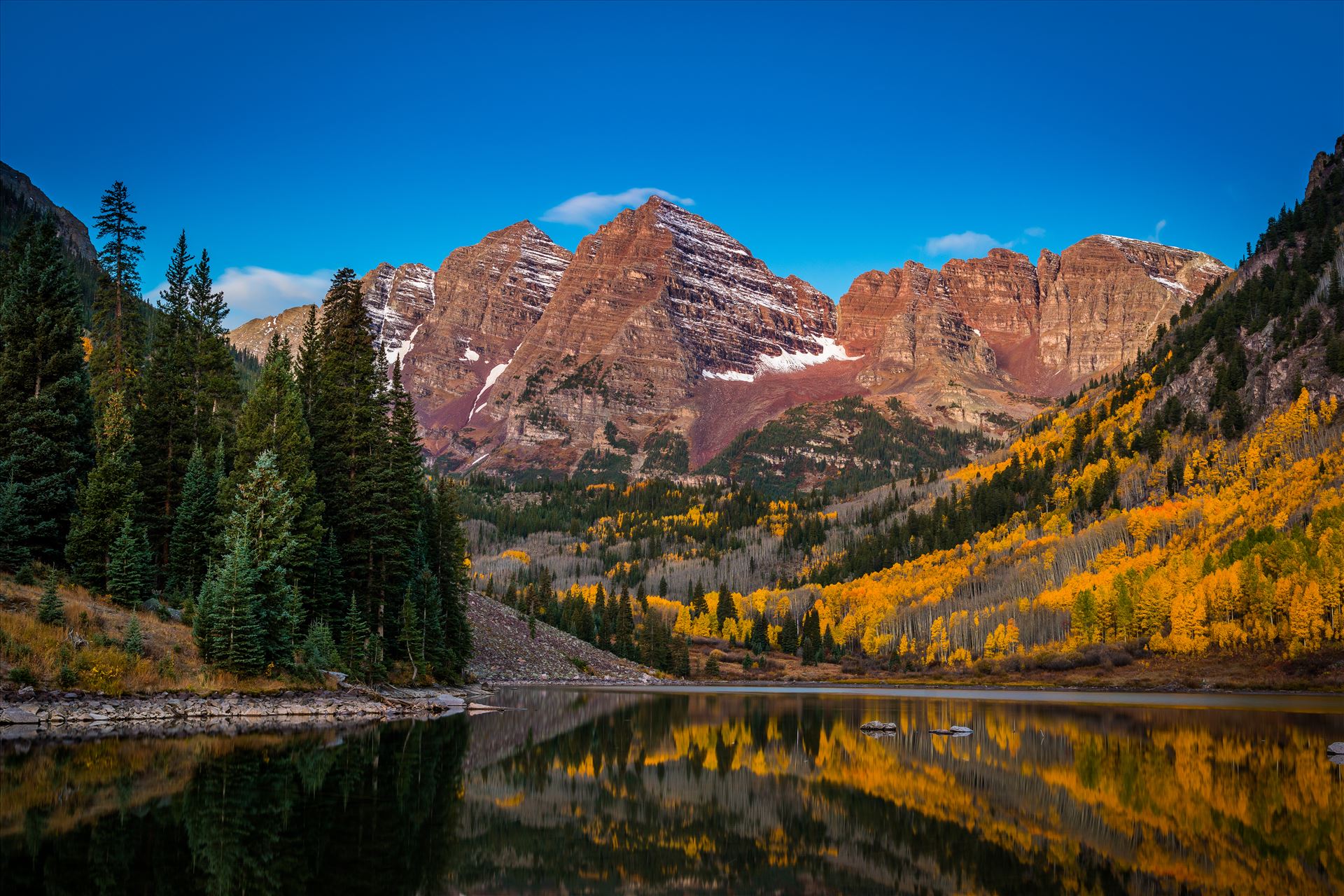 Maroon Bells Before Sunrise Wide - Pre-dawn light casts the maroon hue over Maroon and Pyramid Peaks. The long fifteen second exposure did cost some details in the reflections but was needed at this level of light. by Scott Smith Photos