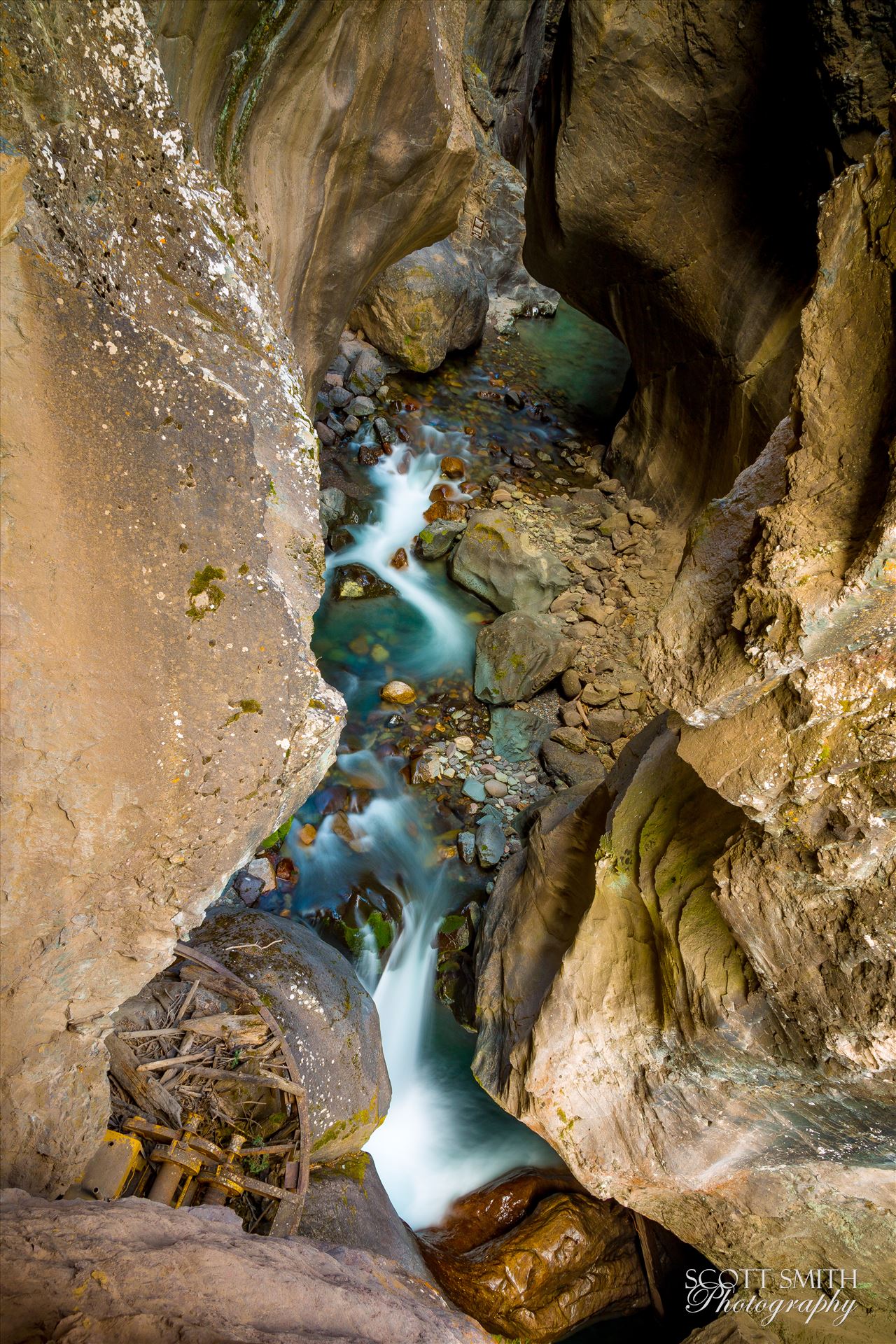 Ouray Box Canyon Falls 2 - The stream leading to an amazing waterfall at the end of a narrow box Canyon in Ouray,Colorado. A difficult shot, both in terms of lighting and location, I leaned over the rail a good amount to avoid getting the walkway in the shot. by Scott Smith Photos