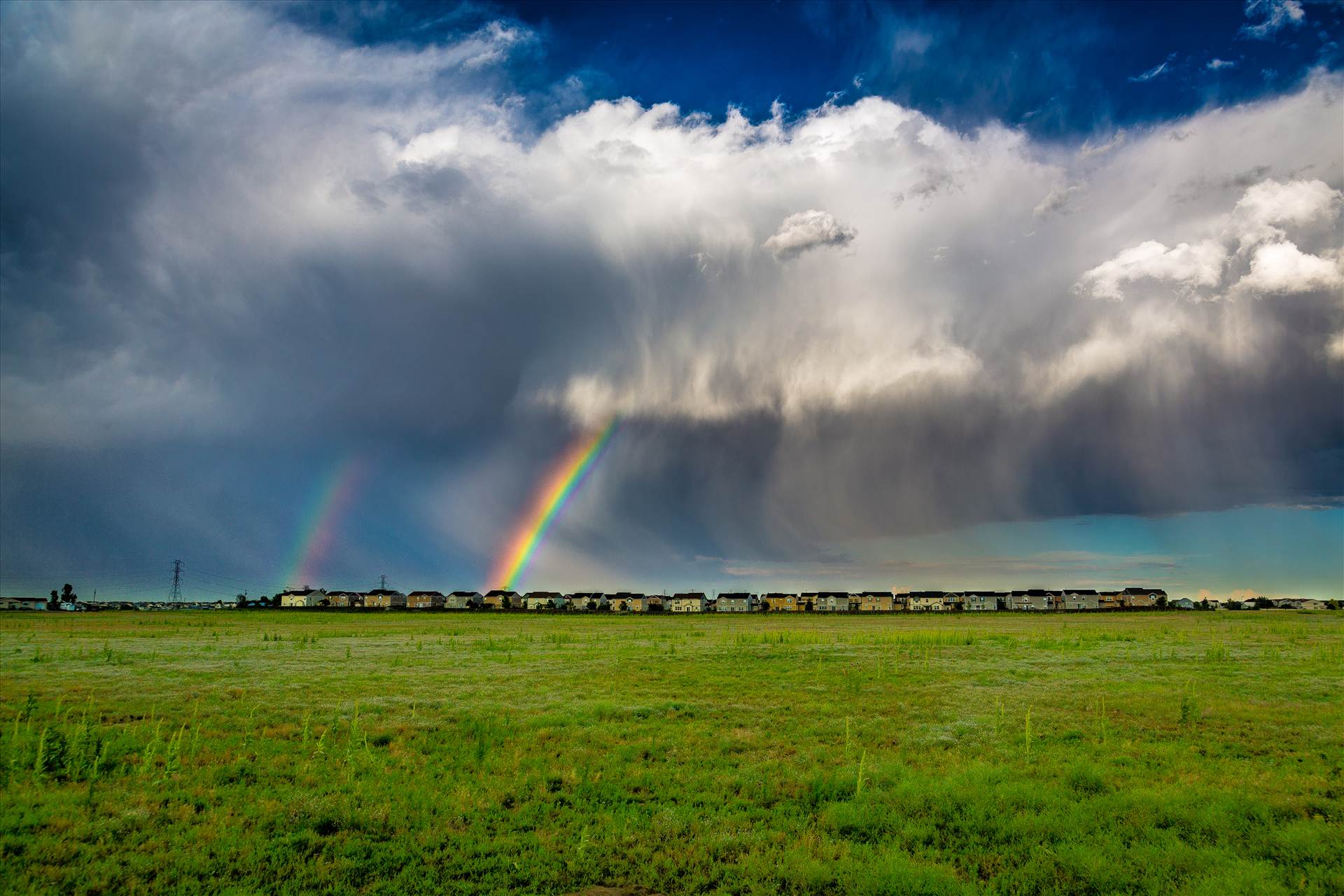 Suburbia Rainbow Connection - A double rainbow breaks through some clouds east of Denver. by Scott Smith Photos
