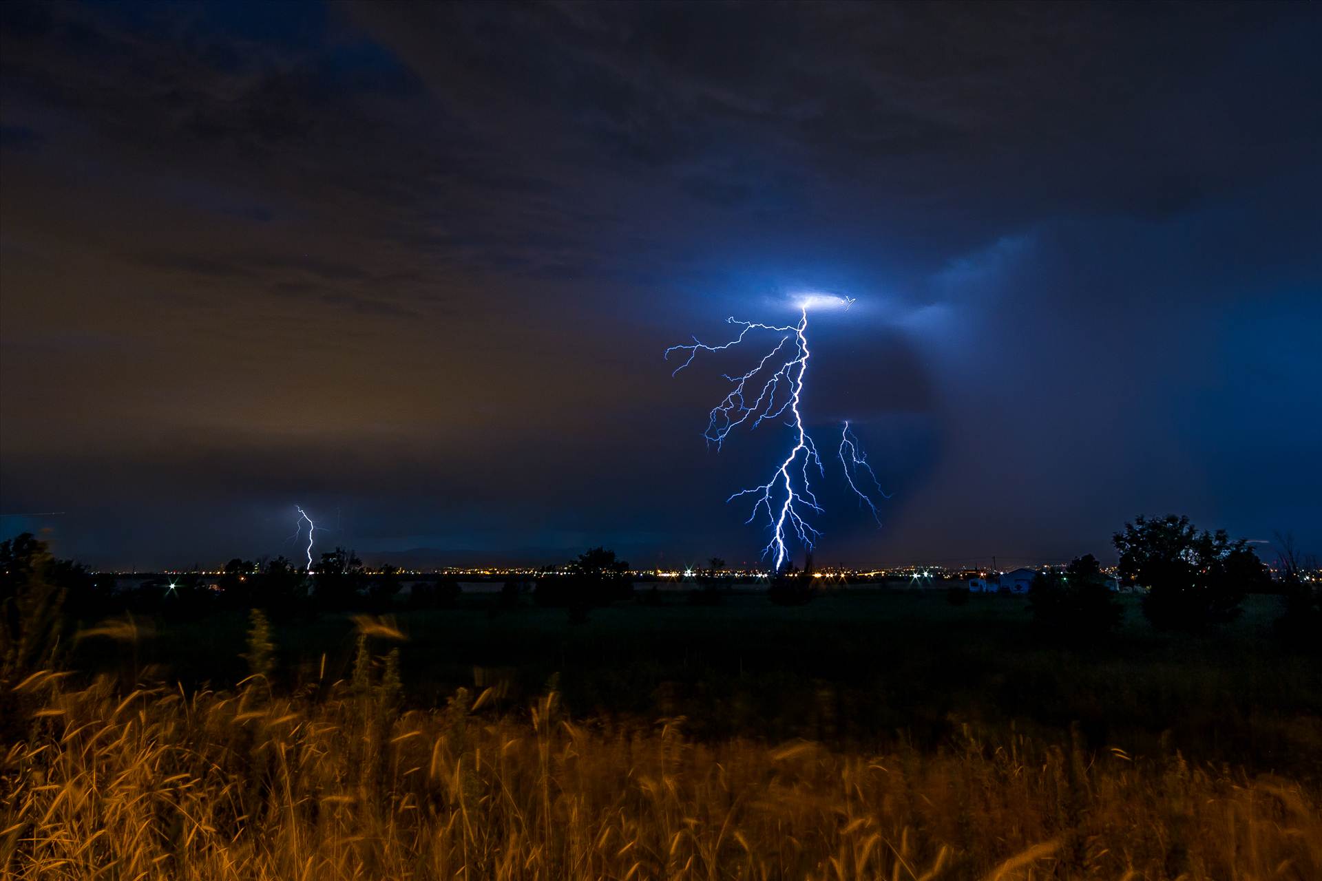 Lightning Flashes 6 - A series of shots from the end of the street, during a powerful lightning storm near Reunion, Colorado. by Scott Smith Photos