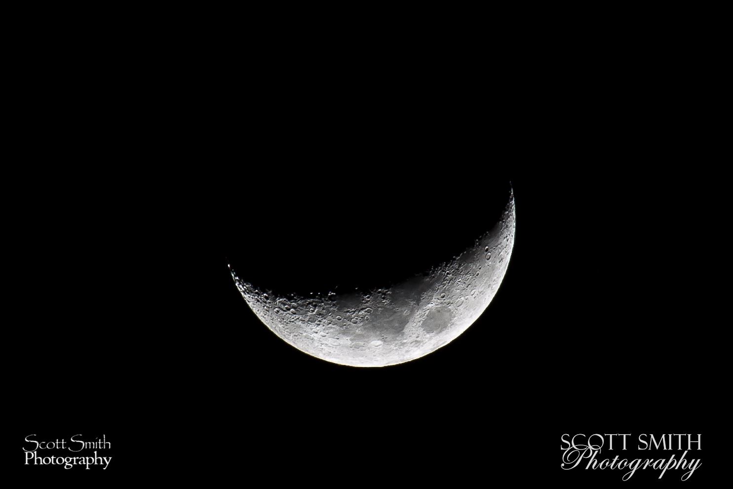 Craters - The craters on the moon pronounced much more when side-lit during the crescent phase. by Scott Smith Photos