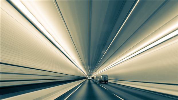 Lines nearly converge to infinity, in this long exposure handheld shot in Eisenhower Tunnel. Opened in 1973, the Eisenhower Tunnel in the Rocky Mountains of Colorado on interstate 70 is highest vehicle tunnel in the world at 11,155 feet. This version B&W.