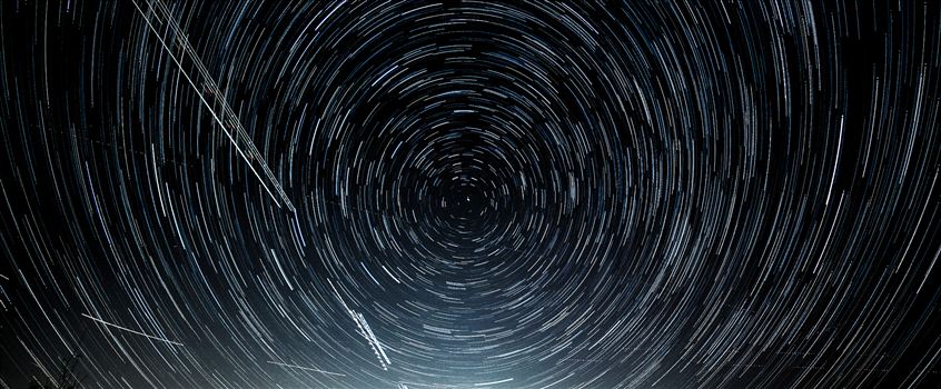 My first attempt at shooting the Aurora Borealis, which turned out to not quite extend down to Denver tonight, turned into my first attempt at merging 103 stacked images into star trails.  The shot is cropped to remove the neighbor's house behind mine.