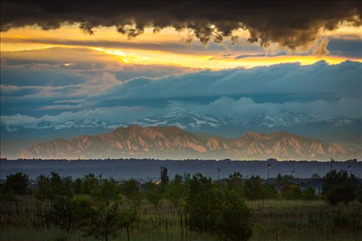 Interesting weather phenomenon as light from the setting sun reflects on a low cloud layer onto the Flatirons in Boulder, Colorado. Taken from Commerce City, Colorado.