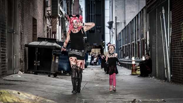 An adorable mother and daughter walking through an alley during Denver's 2015 Zombie Crawl.