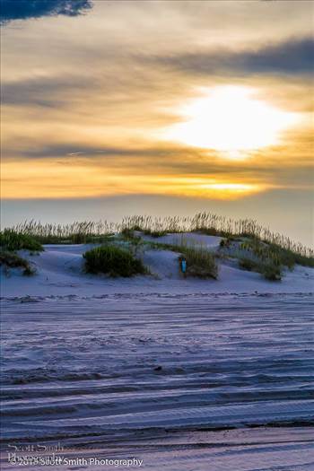 The sun sets over the sand dunes on the outer banks in North Carolina.